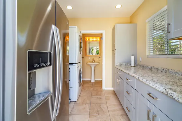 a kitchen with stainless steel appliances granite countertop a refrigerator and a sink