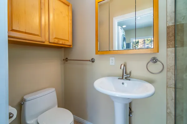 a bathroom with a toilet sink and mirror