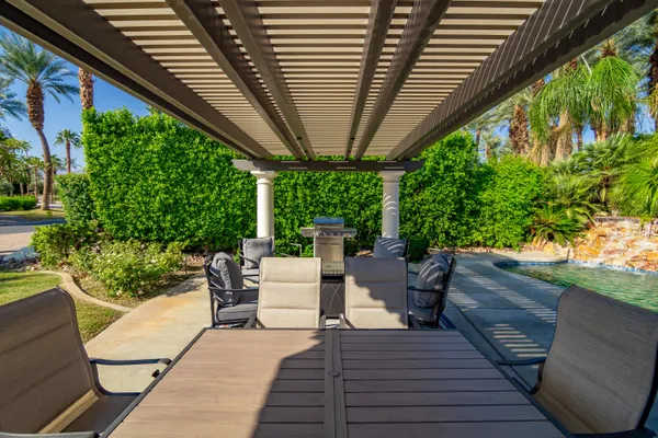 a view of a patio with table and chairs and potted plants