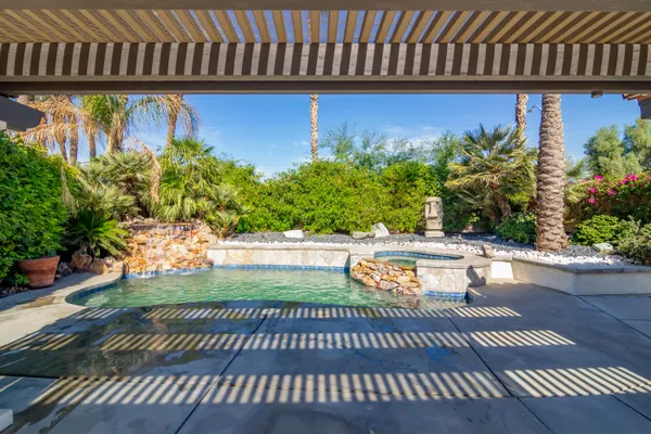 a view of a swimming pool with couches in patio