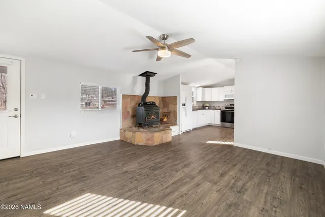 a view of living room with furniture and wooden floor