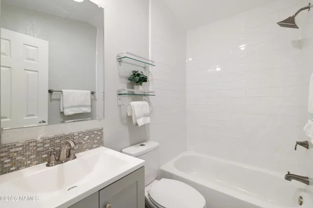 a bathroom with a sink toilet and bathtub