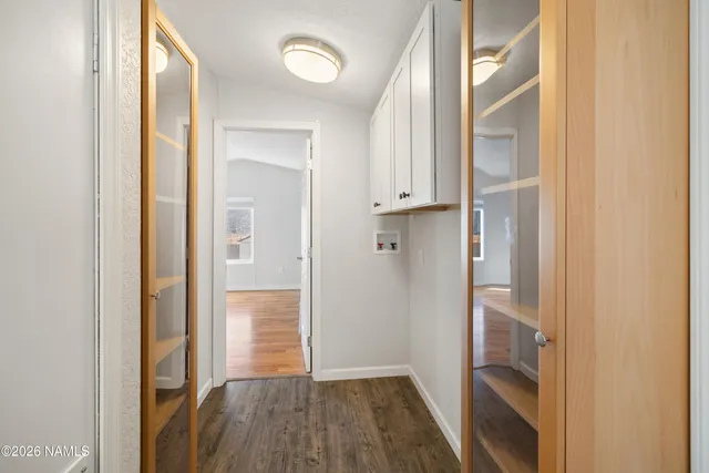 a view of hallway with wooden floor