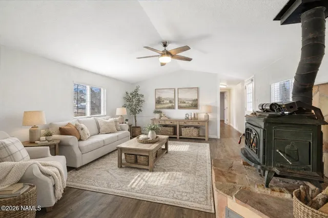 a living room with furniture a rug and a chandelier