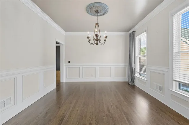 a view of utility room with closet and wooden floor