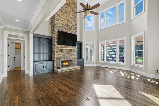 a spacious bedroom with a bed and a flat screen tv