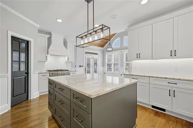 a view of bathroom with a sink and mirror with toilet