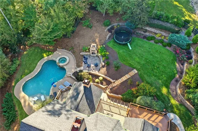 a view of a room with wooden floor chandelier and windows