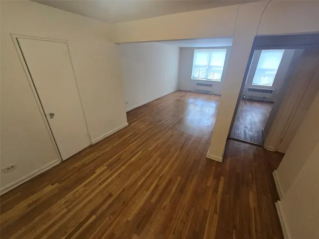 wooden floor in an empty room with a mirror