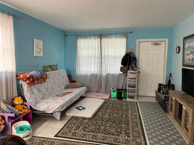 a living room with furniture and a rug