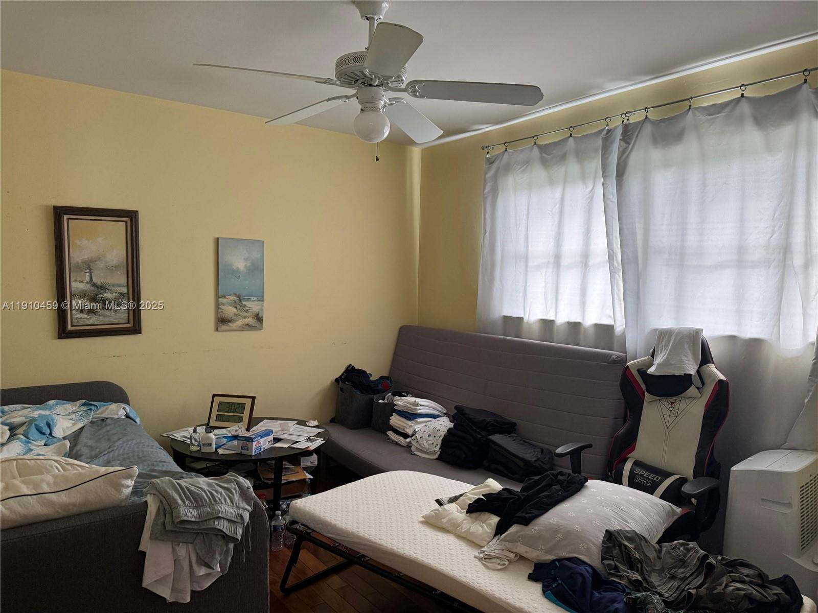 2444 Polk Street, Unit 210 Hollywood, FL 33020 - Photo 4 of 6 a living room with furniture and a window