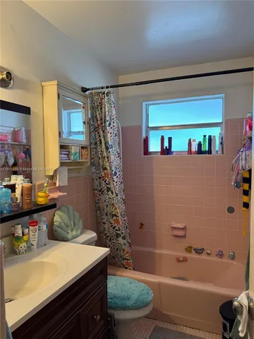a bathroom with a bathtub a sink and a shower
