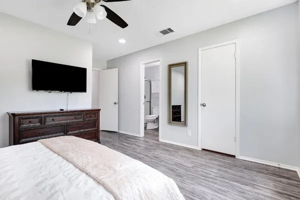 a bedroom with furniture and a flat screen tv