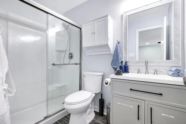 a bathroom with a sink toilet and shower