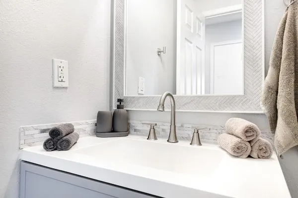 a bathroom with a sink and a mirror