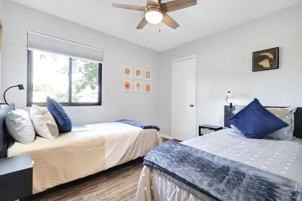 a bedroom with a large bed and a chandelier