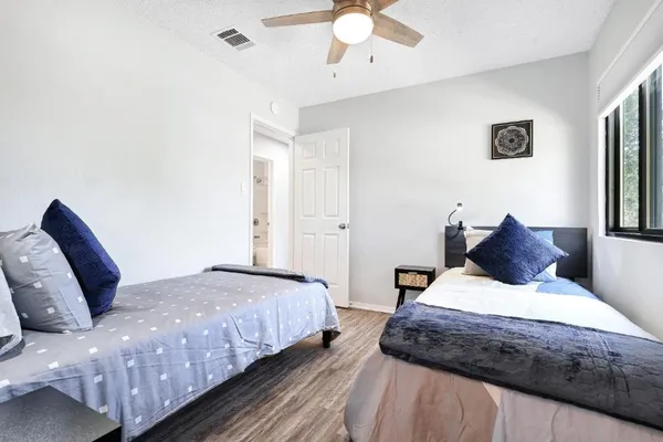 a bedroom with a large bed and a chandelier