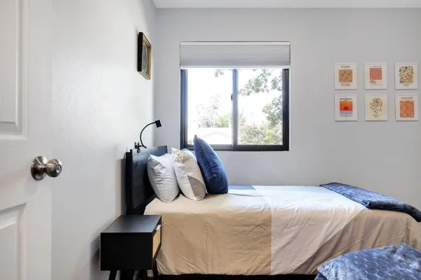 a bedroom with a bed and a window