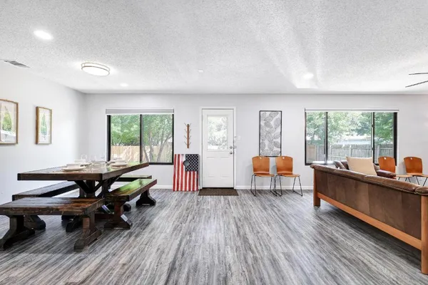 a living room with furniture and wooden floor