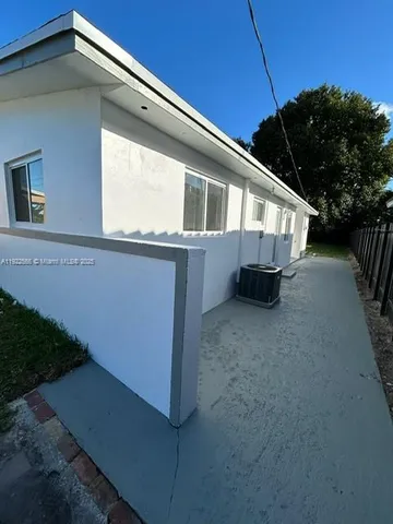 a view of a house with backyard and swimming pool