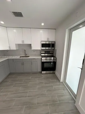 a bathroom with a sink and a microwave