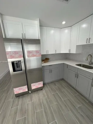 a view of a hallway with wooden floor and closet