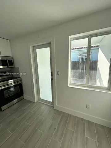 a view of an empty room and wooden floor