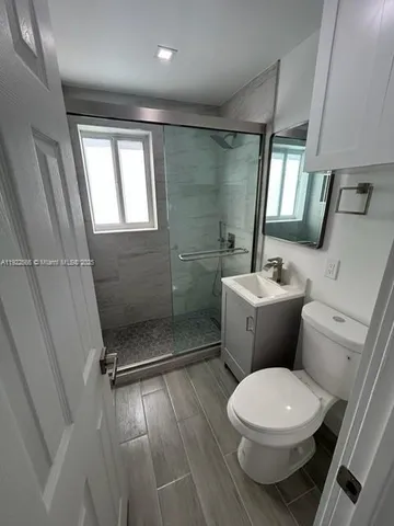 a white toilet sitting next to a bathroom sink