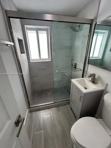 a bathroom with a toilet sink and shower