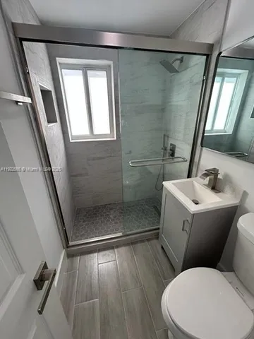 a bathroom with a toilet sink and shower