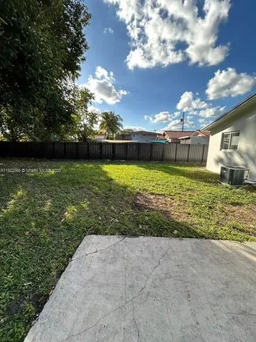 a view of a bedroom with wooden floor and cabinet