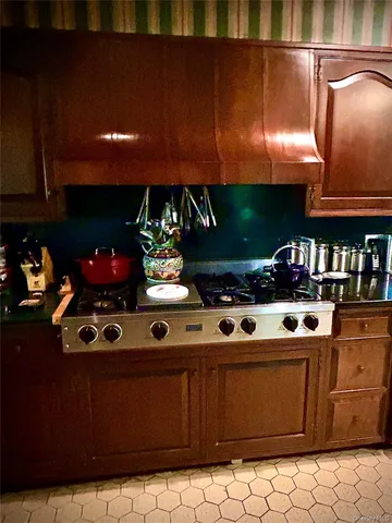 a kitchen with stainless steel appliances granite countertop a stove and a cabinets