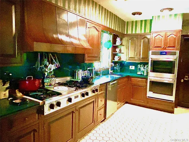 a kitchen with stainless steel appliances granite countertop a stove and a microwave