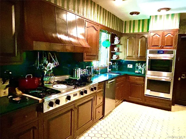 a stove top oven sitting inside of a kitchen