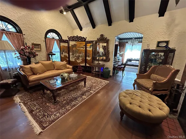 a living room with furniture a fireplace and a floor to ceiling window