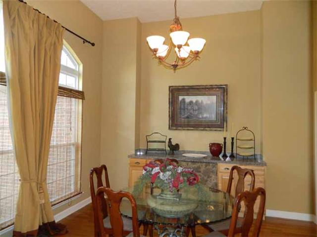 835 Ridgetop Drive Mount Juliet, TN 37122 - Photo 9 of 20 Dining Room: 13 x 12 - large triple window with lazy arch transom above, soaring ceiling, built-in serving cabinet with granite top, hardwood flooring, French Doors leading into the Foyer Area with transom above and decorative wood columns