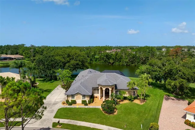 an aerial view of a house with yard and outdoor seating