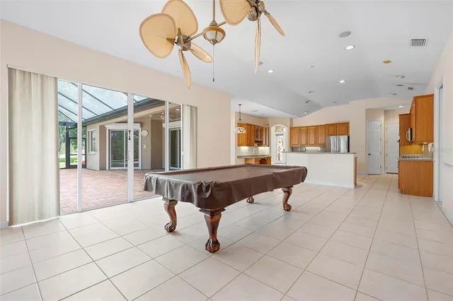 an empty room with windows and ceiling fan