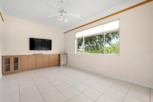 a view of a backyard with table and chairs under an umbrella