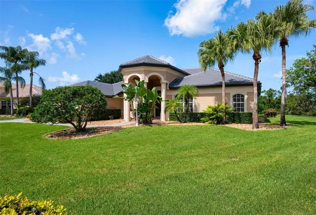 a living room with furniture a flat screen tv and a floor to ceiling window