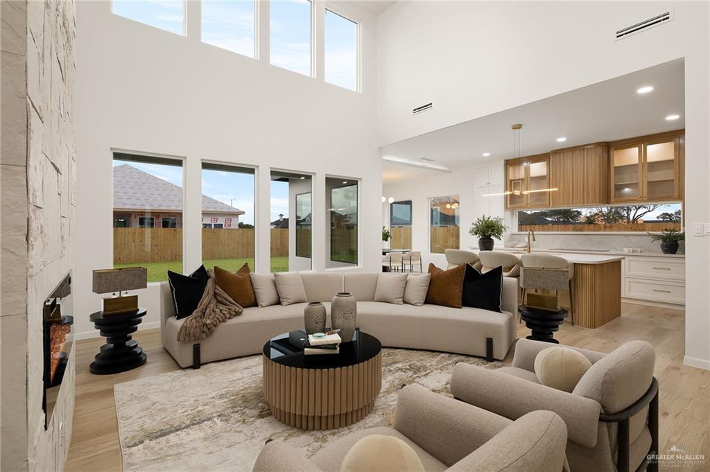 1107 Benjamin Street Mission, TX 78573 - Photo 5 of 19 Expansive living area featuring soaring ceilings and a floor-to-ceiling stacked stone fireplace