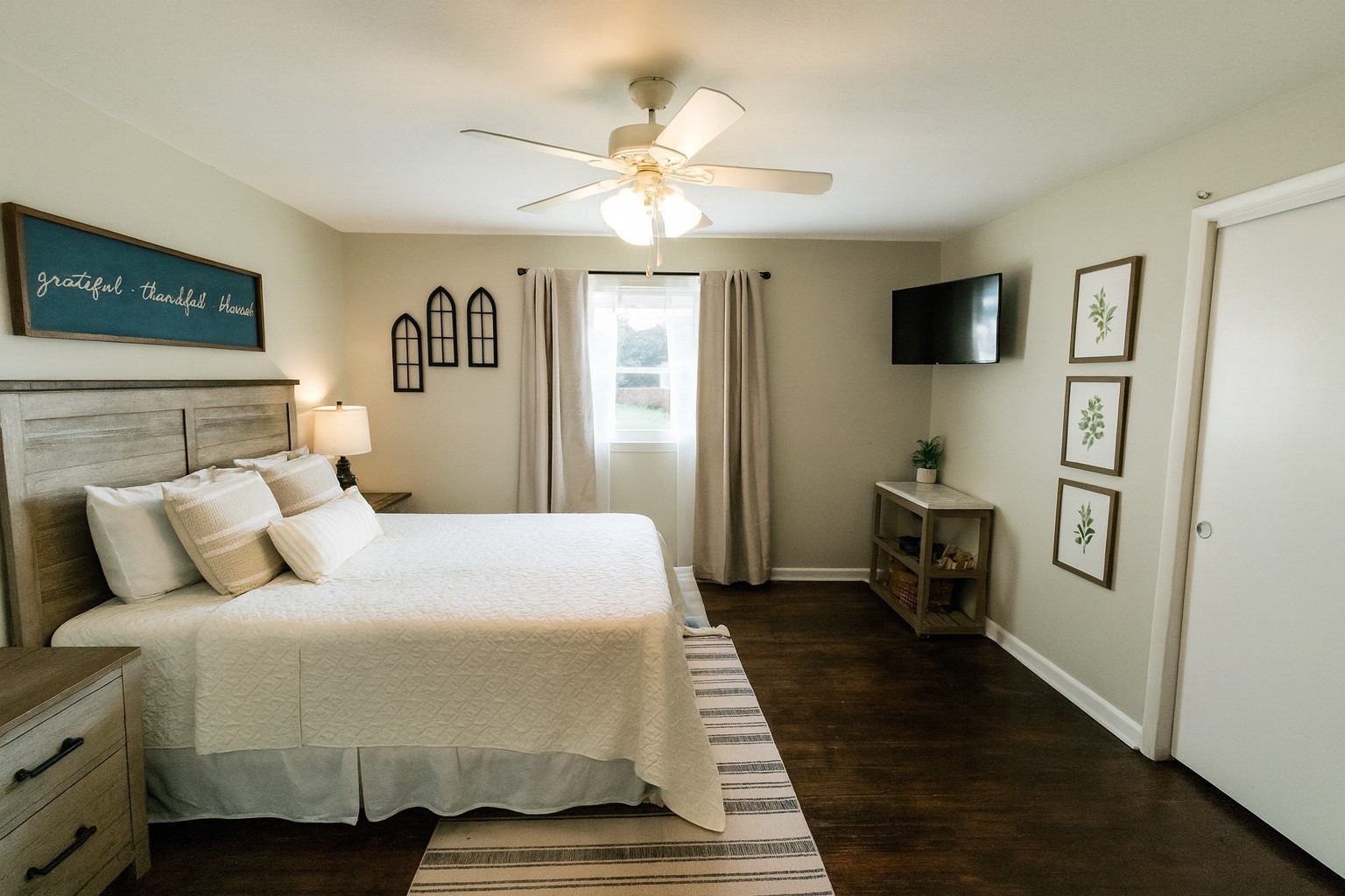 10831 Old Tullahoma Road Tullahoma, TN 37388 - Photo 12 of 25 a bedroom with a large bed a flat tv screen and a ceiling fan