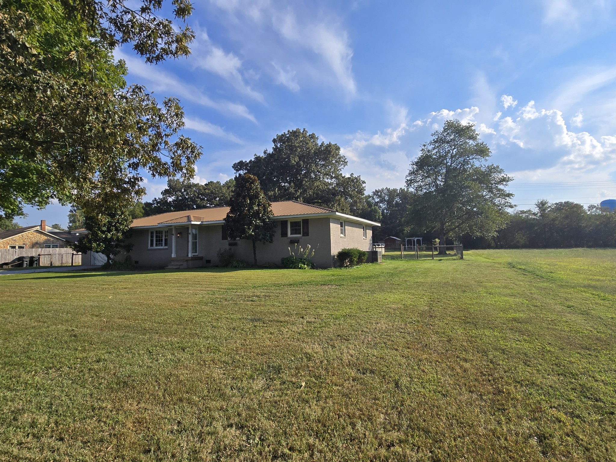 10831 Old Tullahoma Road Tullahoma, TN 37388 - Photo 3 of 25 a front view of a house with a garden and trees