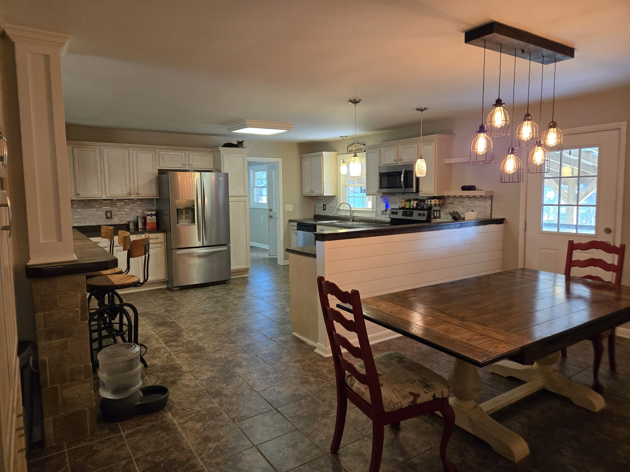 10831 Old Tullahoma Road Tullahoma, TN 37388 - Photo 6 of 25 a kitchen with sink a refrigerator and chairs