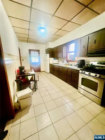 a kitchen with stainless steel appliances a stove a sink a microwave a refrigerator and cabinets