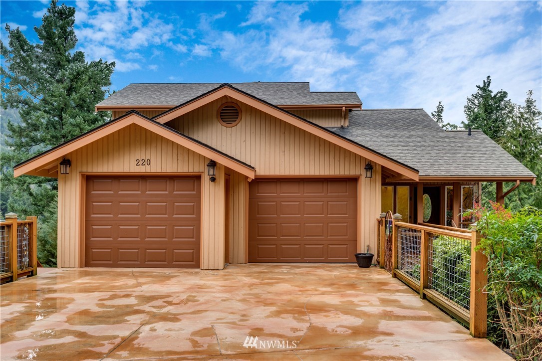 220 Sea Pines Road Bellingham, WA 98229 - Photo 1 of 40 a front view of a house with a yard and garage