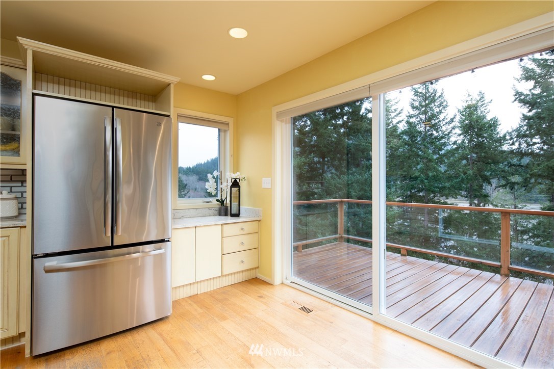 220 Sea Pines Road Bellingham, WA 98229 - Photo 11 of 40 a kitchen with a refrigerator a sink and cabinets
