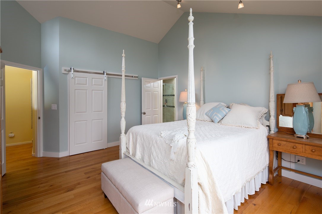 220 Sea Pines Road Bellingham, WA 98229 - Photo 12 of 40 a bedroom with a bed and wooden floor