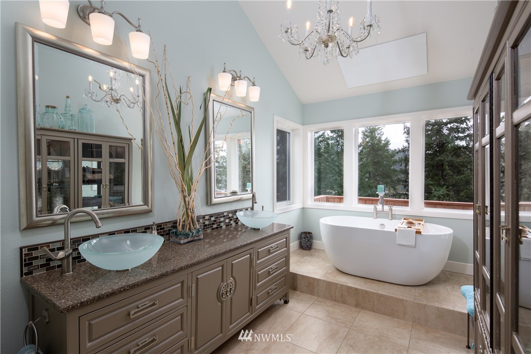 220 Sea Pines Road Bellingham, WA 98229 - Photo 15 of 40 a bathroom with a granite countertop sink a large mirror and a bathtub