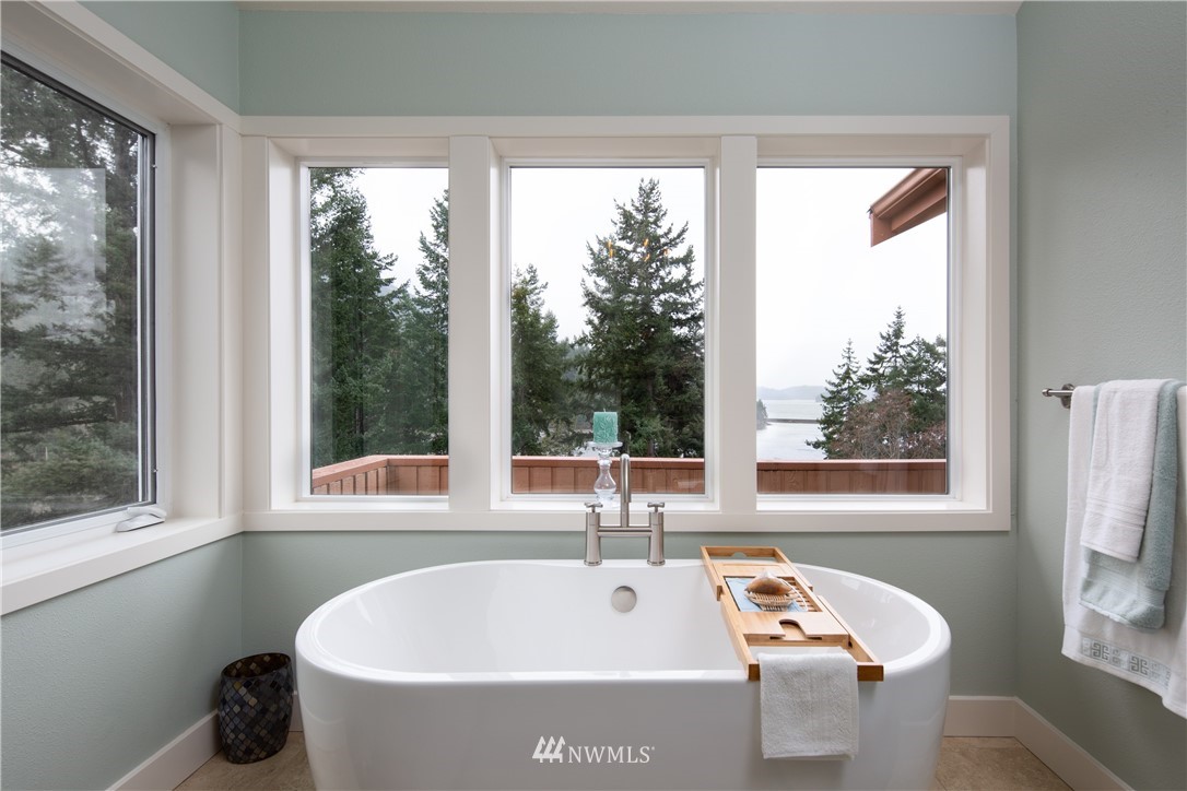220 Sea Pines Road Bellingham, WA 98229 - Photo 17 of 40 a white bath tub sitting in a bathroom next to a window